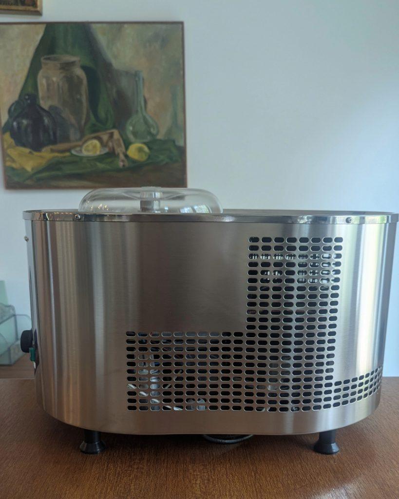 side view of the lello musso lussino 4080 compressor ice cream machine on a wooden table.