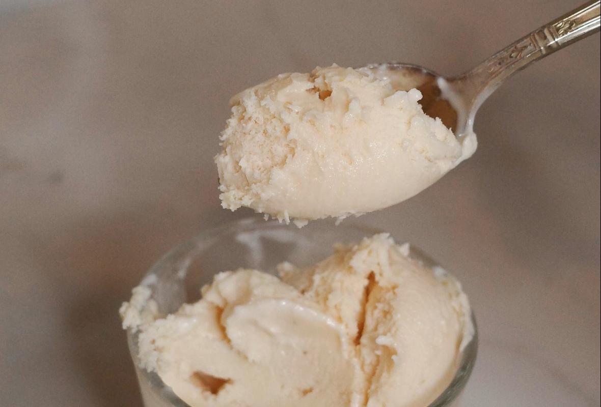 closeup of a spoonful of blood orange ice cream.