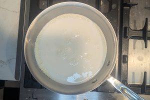 whole milk in a saucepan with sugar, guar gum, and skim milk powder.