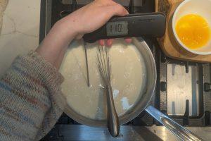 ice cream base in a saucepan with a thermometer reading "110°F".