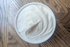 freshly churned blood orange ice cream in a pint container.