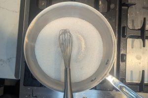 whisked sugar and guar gum in a saucepan with a whisk.