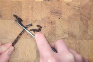 scraping the caviar from a vanilla bean.