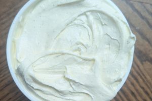 freshly churned vanilla bean honey ice cream packed into a pint container.