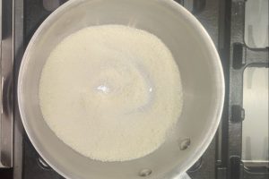 sugar, guar gum, and skim milk powder in a saucepan.