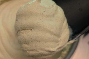closeup of freshly churned pistachio ice cream on a spoonula.