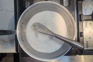 sugar and guar gum in a saucepan with a whisk.
