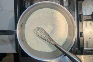 skim milk powder, sugar, and guar gum in a saucepan with a whisk.