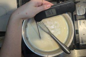 a thermometer reads 165°F dipped into ice cream base.