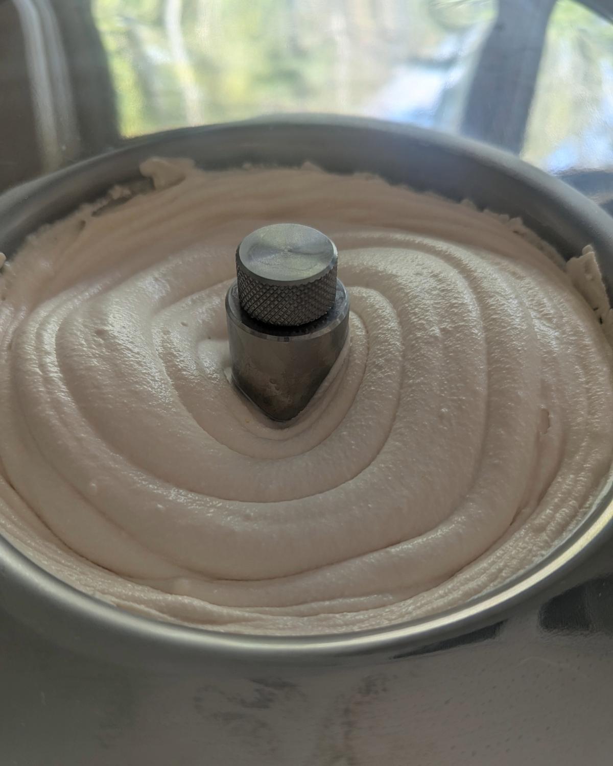 Close-up of freshly churned blood orange ice cream inside a Lello Musso Lussino 4080 compressor ice cream machine bowl.