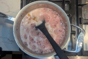 bubbling rhubarb and sugar in a saucepan.