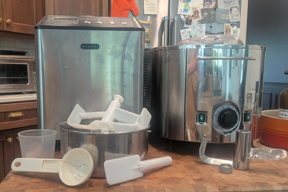 a whynter icm-201sb and a lello 4080 musso lussino next to each other on a butcher block with all their included attachments shown.