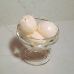 three scoops of sweet cream custard ice cream in a glass.