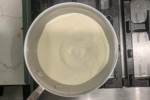 granulated sugar, skim milk powder, and guar gum whisked together in a saucepan.