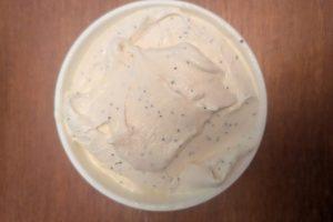 freshly churned lemon poppy seed ice cream in a pint container before hardening.