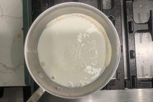whole milk added to skim milk powder and sugar in a saucepan
