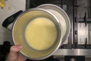 tempering egg yolks in a small bowl.