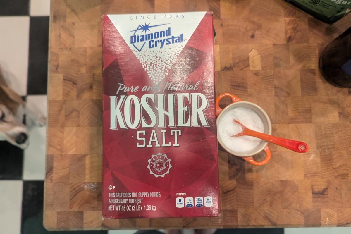 overhead view of a small container of salt next to a box of Diamond Crystal kosher salt.