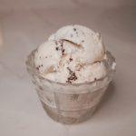 three scoops of stracciatella ice cream in a glass dish.