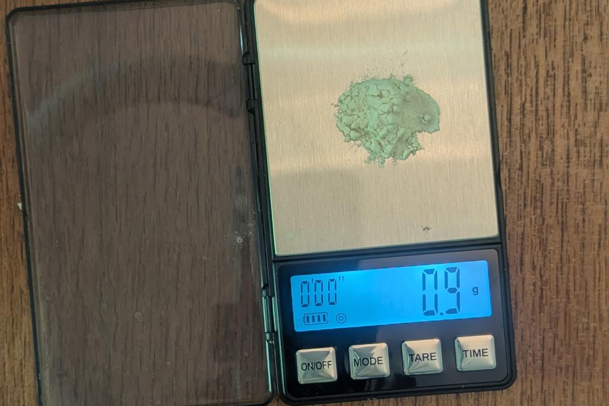 guar gum powder on a scale that reads 0.9 grams
