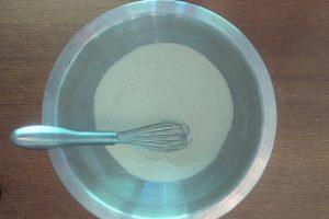 whisked guar gum, sugar, and skim milk powder in a metal bowl with a whisk.