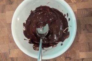 melted chocolate in a white bowl with a spoon.