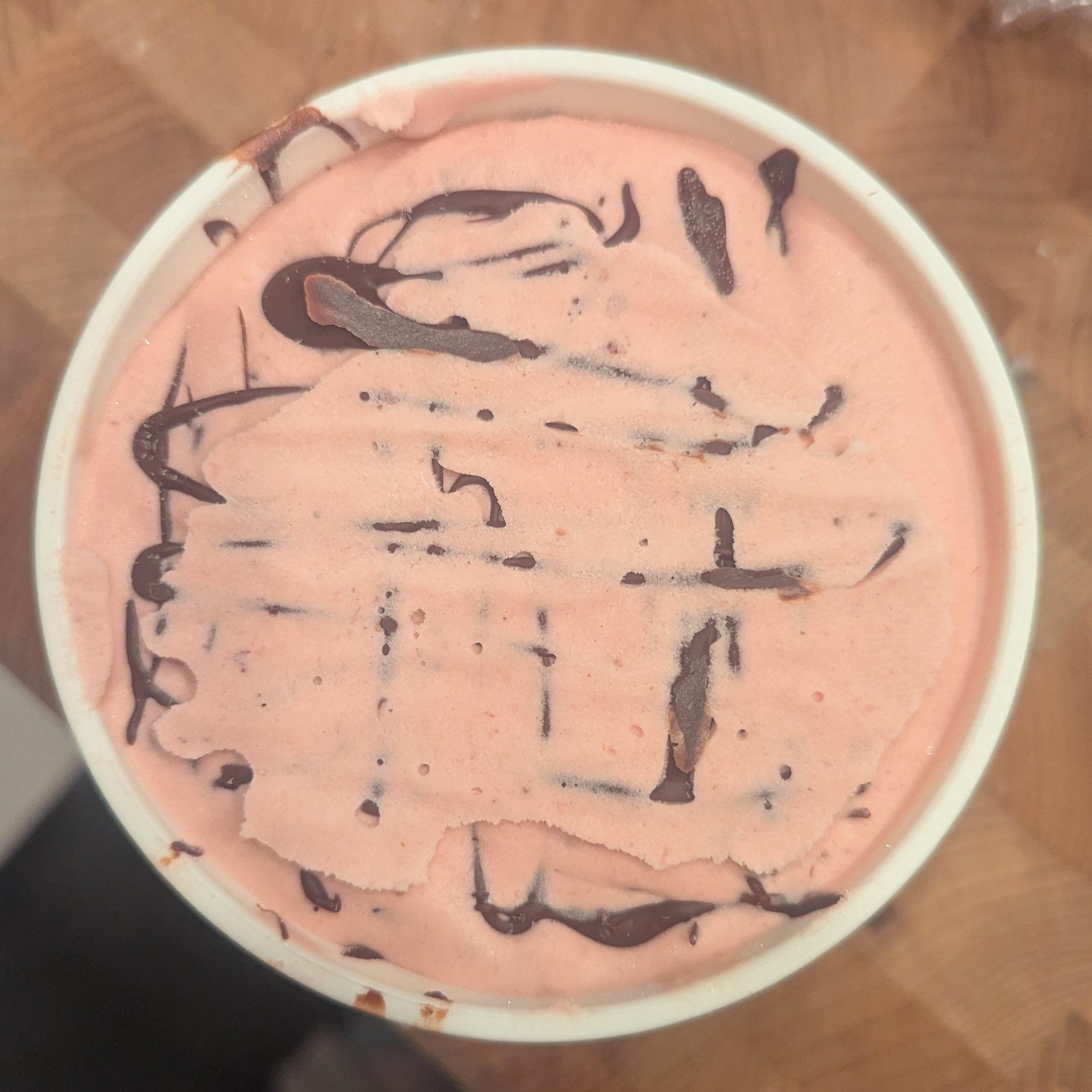 overhead view of a pint of raspberry stracciatella ice cream with too much stabilizer.