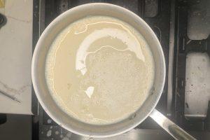 eggs added to coffee ice cream base in a saucepan.