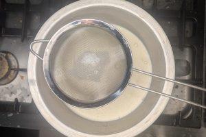 coffee custard strained into a bowl set over an ice bath.