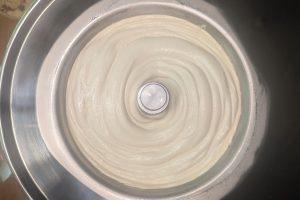 churned coffee liqueur ice cream in the bowl of a compressor ice cream maker.