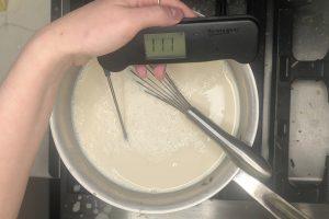 coffee ice cream base heated to 110°F in a saucepan.