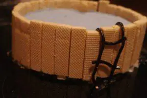 closeup of a licorice ladder balancing on a swimming pool party cake.