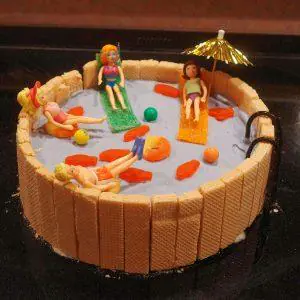 a decorated swimming pool ice cream cake with candies.