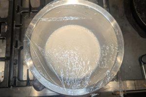 cooled spiced custard ice cream based topped with plastic wrap.