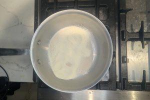 sugar, skim milk powder, and guar gum in a pan with a whisk.
