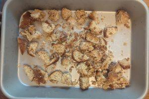 frozen apple cider donut pieces on a baking sheet.
