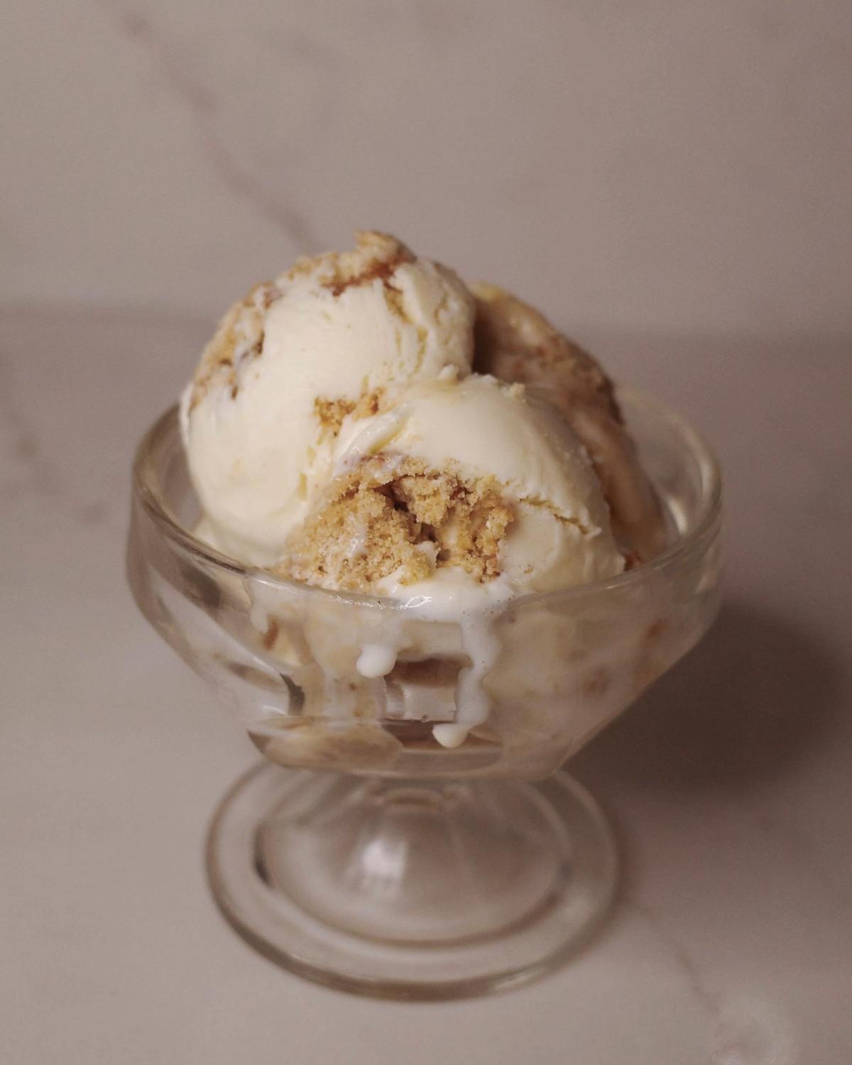 scoops of apple cider caramel donut ice cream in a glass dish.