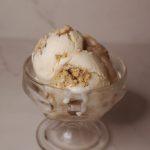 scoops of apple cider caramel donut ice cream in a glass dish.