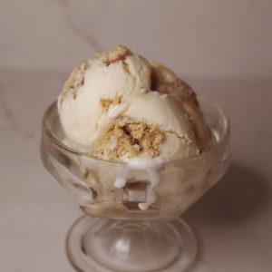 scoops of apple cider caramel donut ice cream in a glass dish.