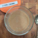 overhead view of apple cider caramel in a glass bowl.