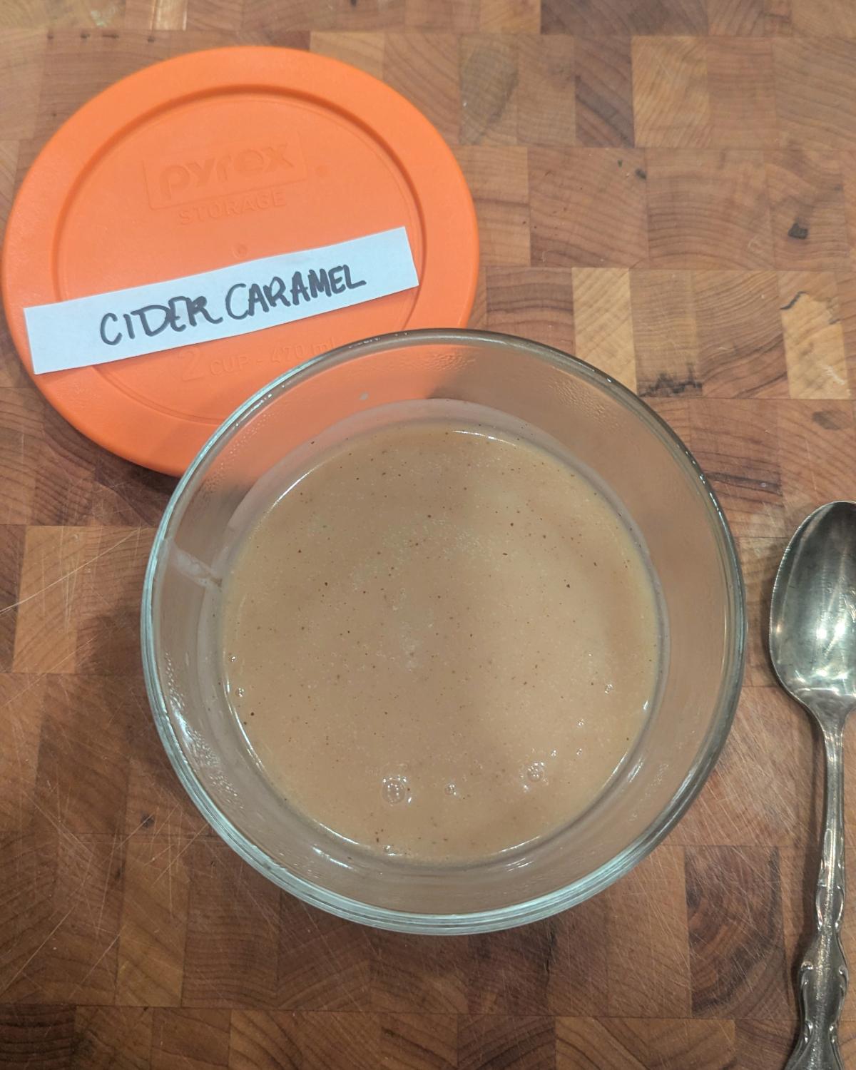 overhead view of apple cider caramel in a glass bowl.