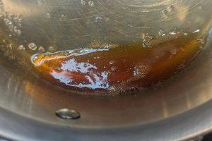 cooked down apple cider syrup in a saucepan.