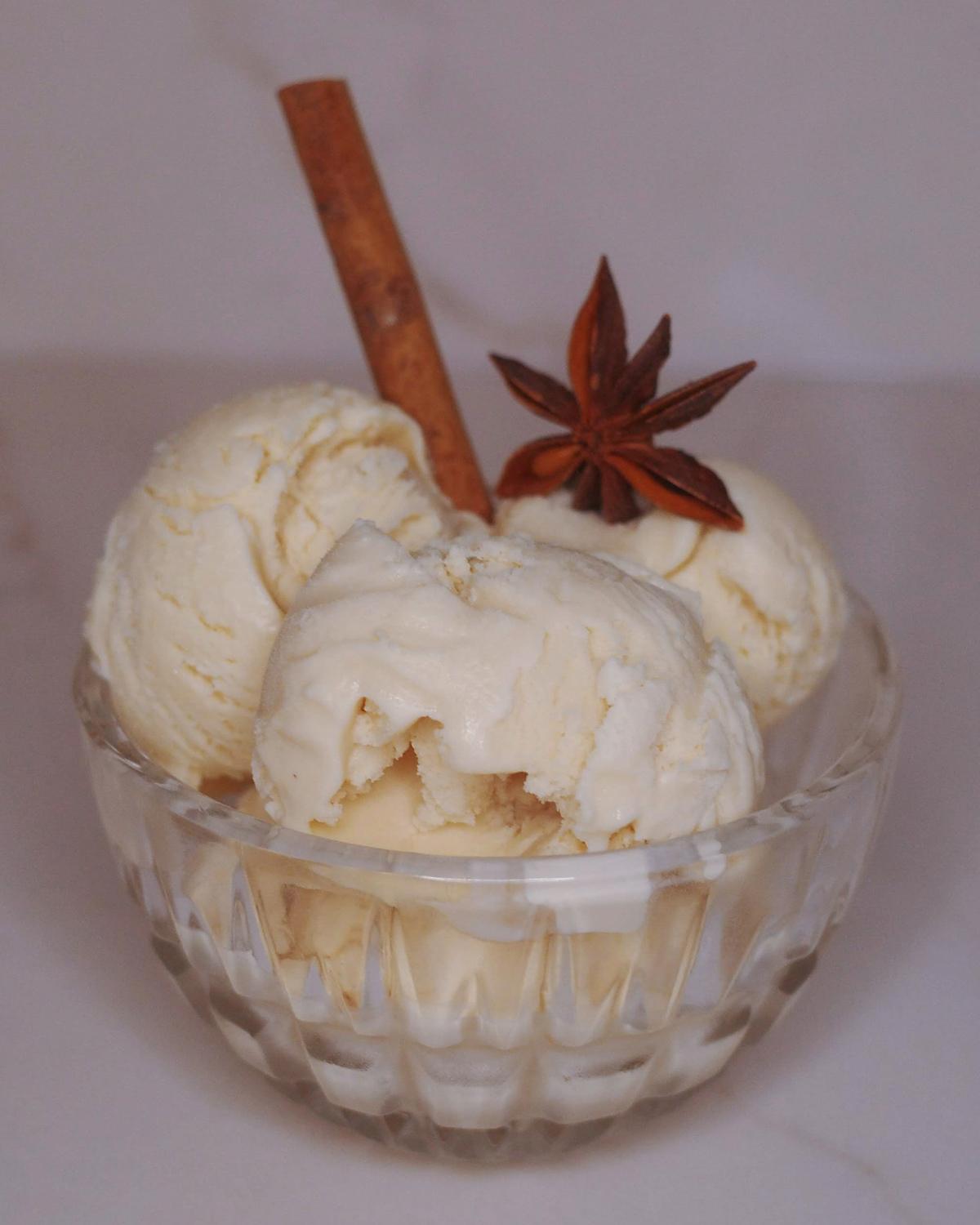 scoops of chaider ice cream (chai apple cider) with anise and a cinnamon stick garnish.