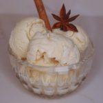 scoops of chai apple cider ice cream with anise and a cinnamon stick garnish.