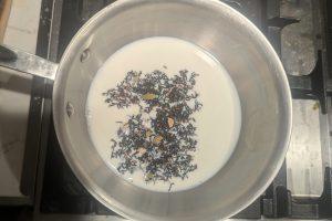 milk and loose leaf chai in a saucepan.