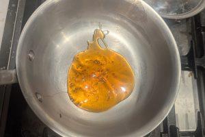apple cider syrup in a saucepan.