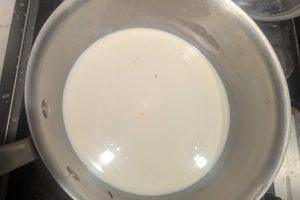 chai-infused milk with the tea strained out in a bowl.
